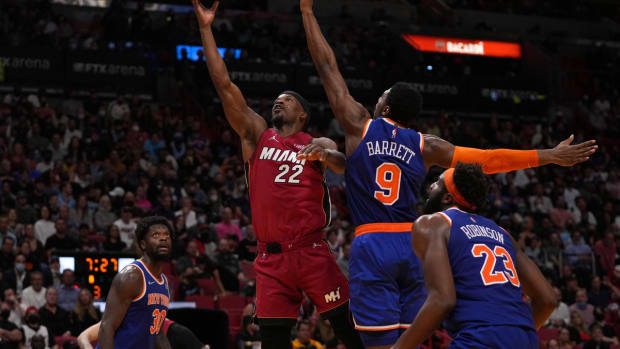 Jan 26, 2022; Miami, Florida, USA; Miami Heat forward Jimmy Butler (22) puts up a shot around New York Knicks guard RJ Barrett (9) during the second half at FTX Arena. Mandatory Credit: Jasen Vinlove-USA TODAY Sports
